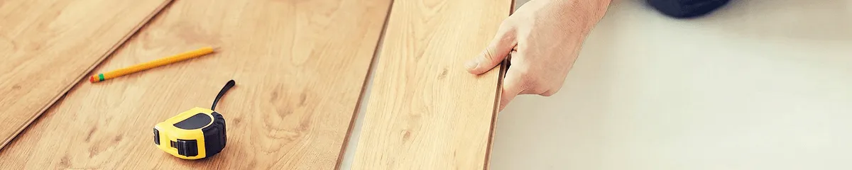 A professional installing wood flooring in Chattanooga, TN