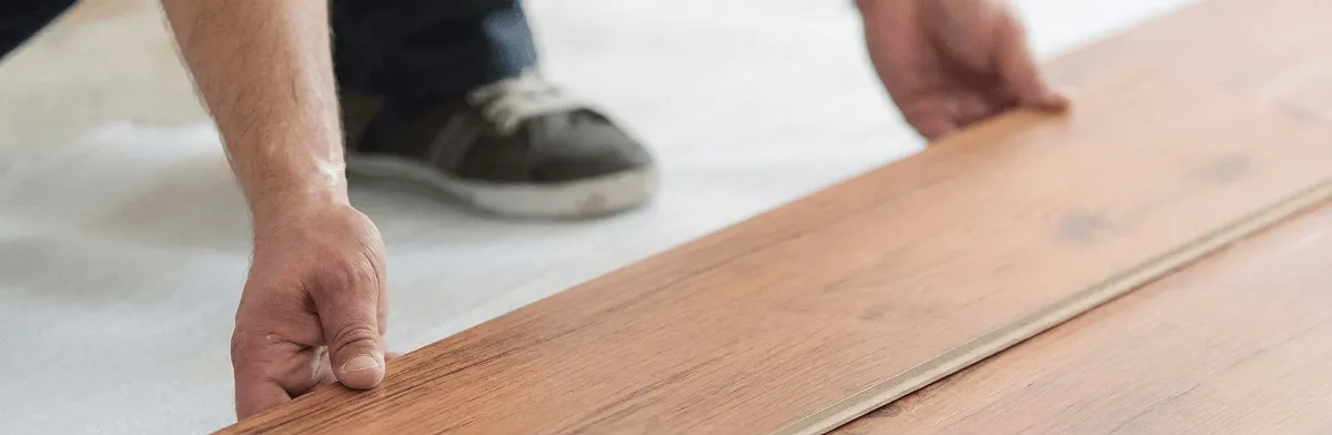A professional installing laminate flooring in Chattanooga, TN